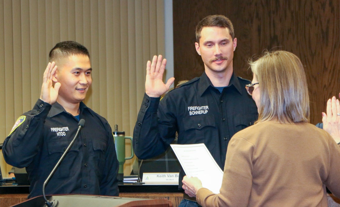 Firefighters Bonnerup and Htoo take oath of office