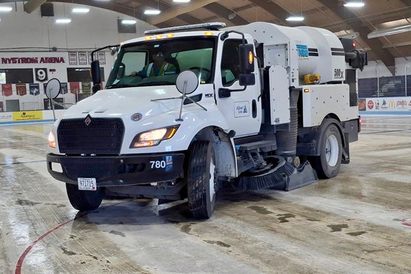 street sweeper cleaning floor in ice rink