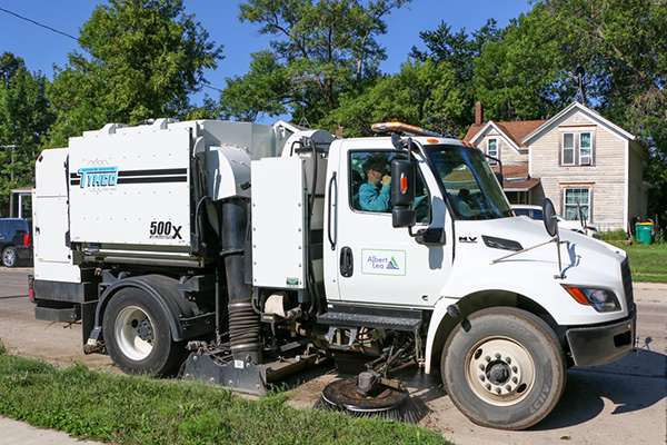 A street sweeping truck hard at work.
